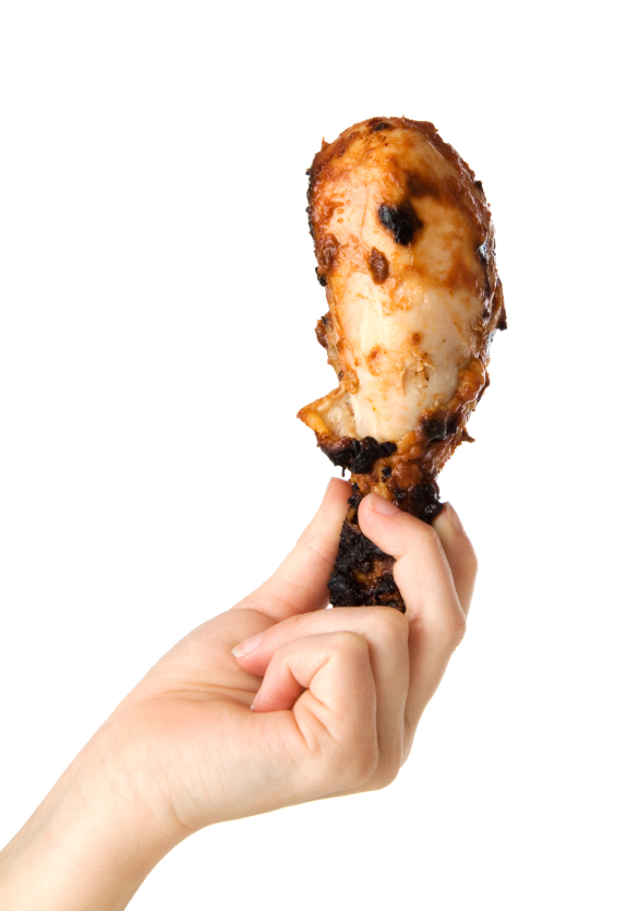 Hand holding Chicken drumstick