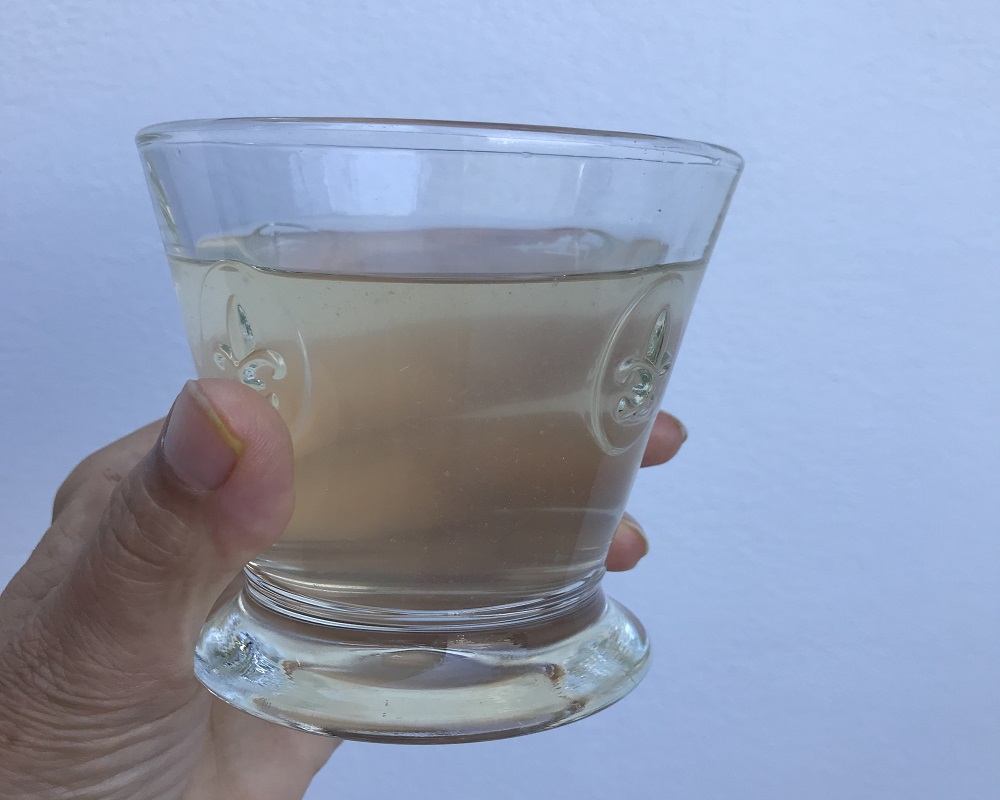 Apple Cider Vinegar diluted in a glass in a hand