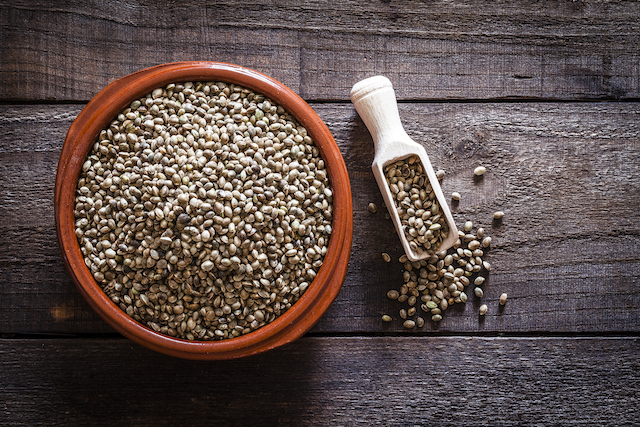 Brown bowl filled with hemp seeds shot from above on rustic wooden table 835875094 1258x838
